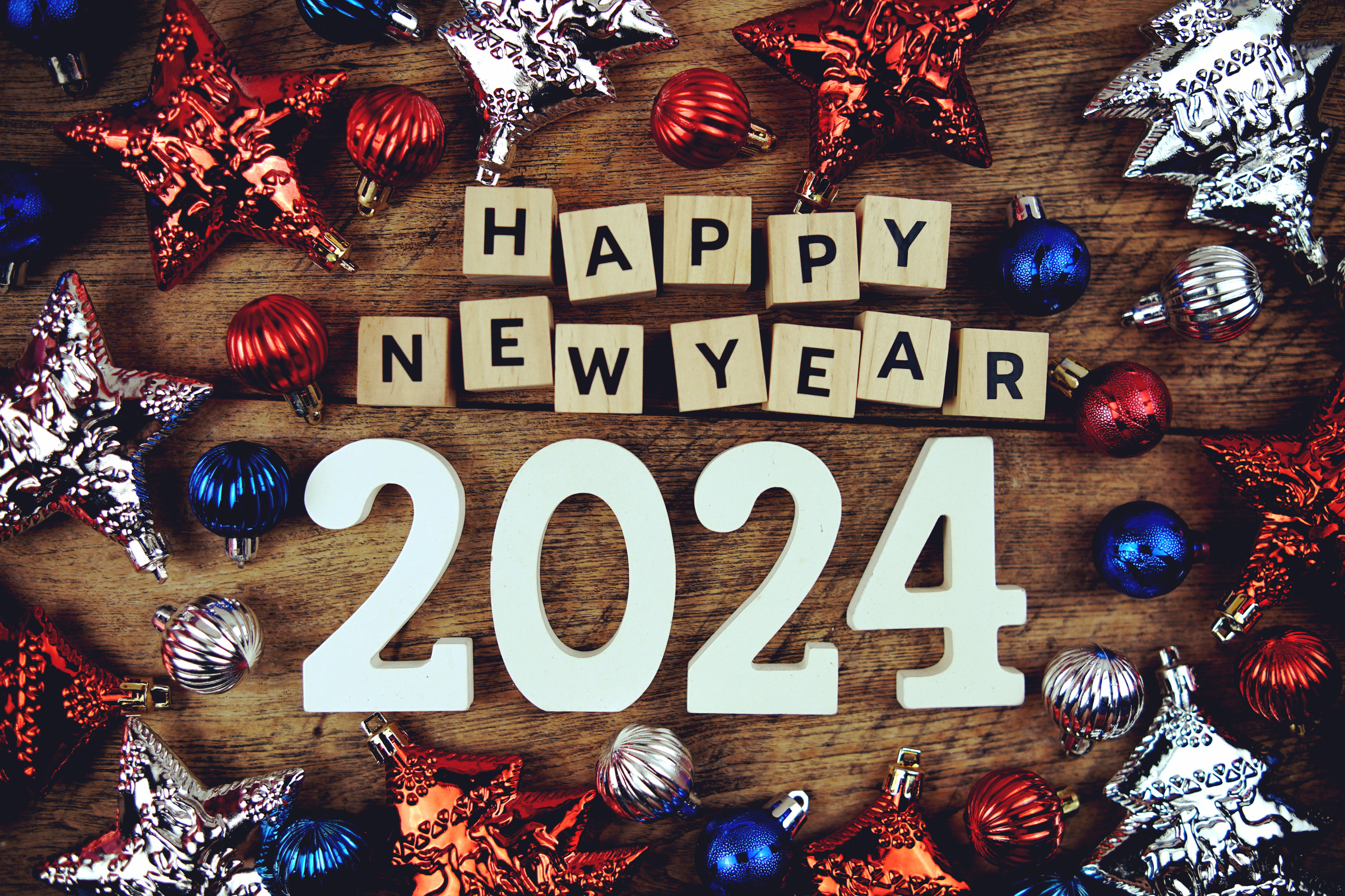 Happy New Year 2024 alphabet letters with Christmasl Decoration on wooden background